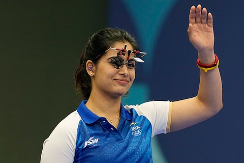 Manu Bhaker waves as she is introduced before the 25m pistol women's final